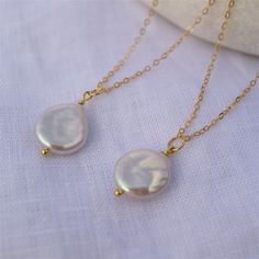 Natural Freshwater Baroque Coin pendant comes on a 14 K gold-filled chain. It is a perfect statement piece and a great necklace to style solo or layered with other necklaces. Please note: each pearl is unique, no two are the same ,  but they all are beautiful. Details: - Baroque coin white pearl size 13-14 mm, very good luster  - Pearl is set on a sterling silver gold plated headpin. - 14 K gold-filled chain with a lobster clasp. - Chain's length : 35 cm ( 14 inch), 40 cm ( 16 inch), 45 cm ( 18 inch), 50 cm ( 20 inch) ► PACKAGING / GIFT BOX All jewellery is carefully packed in our signature Sparklez jewellery box. To reduce waste, we often put an order with multiple pieces in one or two gift boxes. If you would like your order to be boxed separately or if only part of your order is intende Teardrop Gold Plated Necklace For Wedding, Gold Plated Teardrop Necklace For Wedding, Gold Pearl Bridal Necklace With Delicate Chain, Dainty Gold Bridal Necklace With Pearl Drop, Gold Plated Pendant Charm Necklaces For Wedding, Gold Plated Pendant Charm Necklace For Wedding, Dainty Gold Bridal Necklace With Pearl Charm, Gold Bridal Necklace With Pearl Drop As Gift, Gold Dangle Charm Necklaces For Wedding