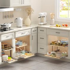 a kitchen with white cabinets and open shelves