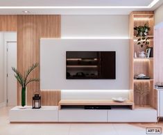 a modern living room with white walls and wood paneling on the wall, tv mounted above the entertainment center