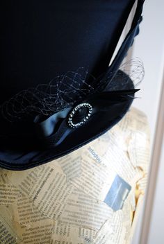 The Liza is a striking cabaret inspired full size top hat. It is covered with beautiful shiny black satin. It is decorated with black ribbon around the crown, black veil, half bow with black crystal buckle and two elegant black goose feathers. Also available as a medium size mini top hat: https://www.etsy.com/listing/256101614/victorian-witch-hatblack-mini-top?ref=shop_home_active_14 Need this TOP HAT in another color?Just send me a message to talk about a custom hat made just for you! This hat Elegant Fitted Hat For Halloween, Victorian Fitted Hats For Costumes, Victorian Fitted Costume Hats, Victorian Style Fitted Costume Hats, Steampunk Top Hat With Curved Brim For Costume, Vintage Top Hat With Curved Brim For Costume Party, Vintage Curved Brim Top Hat For Costume Party, Steampunk Fitted Top Hat For Costume, Gothic Fitted Hat With Short Brim