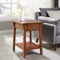 a living room scene with focus on the end table and sofa in the foreground