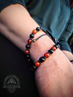 6mm Carnelian & Black Obsidian gemstone beads on black Brazilian waxed cord.  Carnelian promotes creativity, confidence, and empowerment. Black Obsidian is a grounding stone, protects from negative energy & soothes the mind. It can also be used to promote self control. Macrame style knot. Bracelet has adjustable slide knot. Black Agate Bracelets For Healing, Handmade Black Obsidian Beaded Bracelets, Adjustable Black Bracelet With Natural Stones, Black Carnelian Jewelry With Natural Stones, Black Carnelian Jewelry For Gifts, Handmade Black Carnelian Jewelry, Adjustable Black Agate Beaded Bracelet, Adjustable Black Obsidian Beaded Bracelets, Black Agate Beaded Bracelet Gift