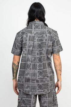 Description: Score some vibes from a 90's concert with this Rasta Print Short Sleeve Shirt! Perfect for warm summer days, its made from breathable cotton and features vibrant eye-catching leaf pattern. Perfect for music festivals and reggae shows, this shirt will show off your Rastafarian beliefs with style. It's comfortable, stylish, and perfect for expressing your love of music and chill summer Rasta vibes. Get your hands on the 90's Print Rasta Short Sleeve Shirt and make a bold statement wit Summer Patterned Cotton T-shirt, Black Tropical Camp Shirt With Graphic Print, Cotton Tops With Retro Print For The Beach, Cotton Retro Print Top For Vacation, Casual Patterned Camp Shirt With Relaxed Fit, Casual Relaxed Fit Patterned Camp Shirt, Cotton Retro Print Vacation Top, Cotton Shirt With Retro Print In Relaxed Fit, Printed Casual Camp Shirt For Streetwear