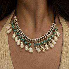 ⭐ Unique Boho Design » Our women's jewelry is characterized by a black band, adorned at the neck with dangling turquoise and golden beads. At each end of the women's bead necklace, there are small white healing stones that provide a fascinating eye-catcher. ⭐ Perfect Length and Width » The surfer necklace is 45 cm long and has a width of 4 cm at the neck, making this women's necklace ideal for achieving a striking statement look. The healing stone necklace is the centerpiece for any Hawaiian wom Bohemian Black Beaded Dangle Jewelry, Bohemian Black Beaded Dangle Necklaces, Bohemian Black Beads Jewelry, Bohemian Black Beaded Choker Jewelry, Bohemian Turquoise Jewelry Fair Trade, Bohemian Turquoise Jewelry, Fair Trade, Bohemian Turquoise Fair Trade Jewelry, Turquoise Bohemian Fair Trade Jewelry, Turquoise Jewelry With Black Beads For Festival