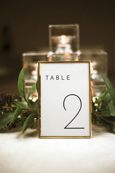 a table number is placed next to some candles