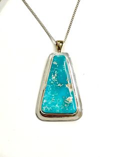 "This Hand Crafted Sterling Silver and 14k gold Necklace was fabricated in my studio using the finest materials. This Pendant is made with some of the finest Battle Mountain turquoise that this mine ever produced.  The color and hardness are indescribable.  \"The 14k Gold chain is not included\"   I will include a 18\" sterling silver ball chain.  The Pendant measures approximately 1 3/8\" tall including the 14k Gold bale, by 3/4\" wide. This Rare Gem High-Grade Intense Ice Blue Gem Battle Mountain Natural Turquoise Cabochon measures approximately 1\" (25.5 mm) by 9/16\" (14.3 mm) and weighs 10.8 Ct.  * IF YOU ARE LOOKING FOR MORE OF MY TURQUOISE JEWELRY PLEASE DO A GOOGLE SEARCH FOR higradeturquoise.com The Blue Gem Turquoise Mine was located in the Copper Basin area southwest of Battle M Silversmith Jewellery, Turquoise Pendant Necklace, Royston Turquoise, Natural High, Custom Pendants, Green Gems, 14k Gold Necklace, Rare Gems, Blue Gems