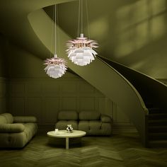 a living room filled with furniture and a spiral stair case next to a green wall