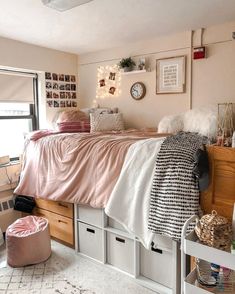 a bedroom with pink and white decor on the walls, drawers, and bedding