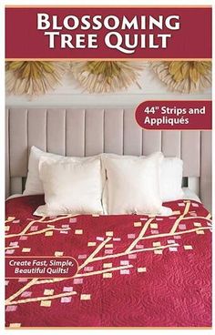 a bed with white pillows and red bedspread