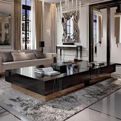 an elegant living room with black and white furniture, chandelier and mirrored coffee table