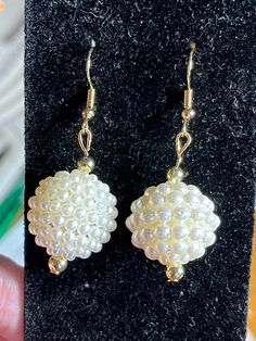 Hello and welcome to my store! Up for sale here is a pair of white pearl sphere earrings. They are nestled between 2 gold seed beads and they dangle from gold fish hook wires. These earrings dangle to 1.5 inches long and they are about .75 inch wide at their widest point. They are perfect for a girl or woman. Thanks for looking! White Pearl Earrings With Gold Beads, White Round Earrings With Gold Beads, White Gold Beaded Round Earrings, Pearl Drop Earrings With Gold Beads, White Pearl Earrings With Round Beads, White Beaded Earrings With Pearl Drop, White Round Beaded Earrings With Pearl Drop, Pearl Earrings With Gold Beads For Gift, Sphere Earrings