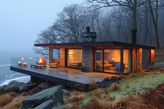 a house on the edge of a cliff with candles lit