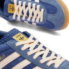 Find ADIDAS Gazelle Indoor on Editorialist. An indoor training shoe originally released in ’79, the adidas Gazelle Indoor has certainly stood the test of time. This time round, they come presented in hairy blue suede on the upper, accented with white through the laces and the all-important 3-Stripes. A translucent gum rubber sole sits underfoot, rounding off the style with a retro touch. Suede Upper, Lace Up Closure, Gum Sole, Adidas. Adidas Gazelle Indoor in Dark Blue/Bliss Orange/Preloved Ink, Gazelle Outfit, Adidas Gazelle Indoor, Shoe Wishlist, Blue Suede Shoes, Shoe Inspo, Retro Sneakers, Adidas Gazelle, Dream Shoes