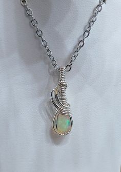 Crystal/Stone: Opal Pendant Length: 1 1/4 inches long Wire wrap metal: Sterling silver wire Chain: Stainless steel chain with claw clasp measures about 24 inches in length. Adjustable Wire Wrapped Sterling Silver Necklace, Adjustable Sterling Silver Wire Wrapped Necklace, Silver Teardrop Wire Wrapped Crystal Necklaces, Silver Teardrop Crystal Necklace Wire Wrapped, Silver Teardrop Wire Wrapped Crystal Necklace, Sterling Silver Wire Wrapped Teardrop Pendant, Sterling Silver Wire Wrapped Teardrop Pendant Jewelry, Sterling Silver Teardrop Pendant Jewelry Wire Wrapped, Sterling Silver Teardrop Pendant Wire Wrapped Jewelry