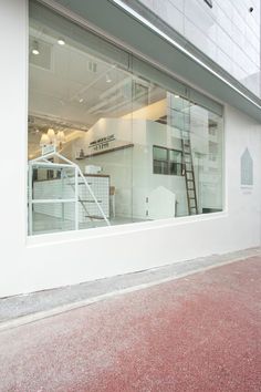 an empty store front with a fire hydrant in the foreground and stairs leading up to it