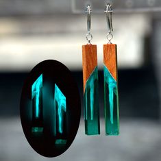 "Glow in the dark epoxy earrings. Wood resin earrings secret wood jewelry. 3d resin art Gift for women ♥  You will be sent exactly the sample that you see in the photo and video.  ♥♥ Please see the current discounts in the shop announcement: https://www.etsy.com/shop/TSMDecorations Handmade from mahogany wood and clear art resin. Glow in the dark. 925 sterling silver Ear Hooks. Your feeling of grace and elegance will benefit a little with these earrings. Looks very good!  These earrings want to replenish your collection. Dimensions in inches: Length 2.2\"; Drop (full) length 3.07\"; Width 0.28\" x 0.28\"; Dimensions in mm: Length 56 mm; Drop (full) length 78 mm; Width 7 x 7 mm. Weight 4.0 g/unit. ♥♥ You can see more wood and resin earrings here: https://www.etsy.com/shop/TSMDecorations?sec Resin Art Christmas, Glow In The Dark Epoxy, 3d Resin Art, Wood Resin Earrings, Epoxy Earrings, Dark Blue Earrings, Art Christmas Gifts, Earrings Wood, Epoxy Resin Art