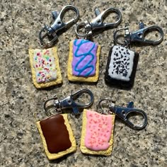 four cookies with icing and sprinkles on them are sitting on a table