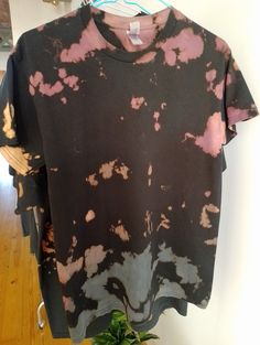 Hello and welcome to my store!  This is a Gildan brand 100% cotton T-Shirt which I reverse dyed using bleach (all bleach is then removed by washing) This shirt style is unisex and the brand is from the US so the sizes are quite large and oversized. This is the perfect addition to any wardrobe, super comfy and looks great all year round. It would make a great unisex gift for people of all ages! Care instructions I would recommend washing on a cool wash with like colours.  Tie dye, Tiedye, t-shirt, tie dye shirt, tie dye tee, handmade tie dye shirt, hand dyed tee, tie dye t-shirt,  handmade, tee shirt, t shirt, shirt, cotton, fiber reactive dye, Adult Shirt, Reverse tie dye, Acid Wash Cotton T-shirt With Natural Dye, Casual Cotton T-shirt With Natural Dye, Hand Dyed Washed Black Short Sleeve T-shirt, Short Sleeve Cotton T-shirt With Natural Dye, Black Pre-washed Cotton Tops, Casual Black Pre-washed T-shirt, Pre-washed Cotton Grunge T-shirt, Grunge Pre-washed Cotton T-shirt, Relaxed Fit Tie-dye T-shirt With Natural Dye