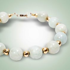 Beautiful white Jade represents purity and spirituality. These gorgeous beads are enhanced by gold-filled spacers for a sophisticated look. White Jade (11mm) Gold-filled Length: 8.5" Different Jade colors and sizes available, on request Elegant Jade Jewelry With Large Beads, Elegant Jade Jewelry With Spacer Beads, Elegant Beaded Bracelets For Meditation, Elegant 8mm Beads Bracelet For Meditation, White Jade Jewelry With 8mm Beads, Elegant Jade Bracelets With Polished Beads, White Single Strand Jade Jewelry, Elegant White Bracelets With Large Beads, Elegant White Bracelet With Large Beads