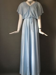 True vintage item description: Classic vintage 70s baby blue bridesmaid long maxi dress. Macrame like mesh overlay bodice, flutter sleeves, zips up back. Matching skinny tie belt. V neckline. The dress measures bust 36 waist 27 hips 42 and is 53 inches long. The fabric is polyester. In mint ready to wear condition. We value and appreciate your business and we prove it! Please enjoy our customer satisfaction guarantee. Much love! Blue Goddess, Long Sleeve Knit Dress, Blue Bridesmaids, Mesh Overlay, Button Up Dress, Long Maxi, Flutter Sleeves, Classic Vintage, Tie Belt