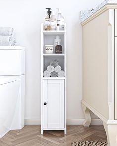 a white cabinet with towels on it in a bathroom