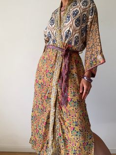 "This is one of a kind patchwork, upcycled silk robe Made free size with wrap tie closing and wide kimono sleeves  Easy and fun to wear around the house or outside as a urban boho style,  flowy kardigan with jeans and tshirt  It is very comfy and feels soft and light  the material is colorful and flowy  made into this unique stylish over all MEAESURE free size length 55\" MATERIAL *polyester  *no lining CARE INSTRUCTIONS  * Wash in warm water * Hand wash recommended * Hang to dry Please visit al Bohemian Tie-waist Maxi Dress Beach Cover-up, Bohemian Tie Waist Maxi Dress As Beach Cover-up, Bohemian Tie Waist Maxi Dress For Beachwear, Bohemian Tie Waist Maxi Dress For Beach Cover-up, Bohemian Floral Print Wrap Maxi Dress, Multicolor Wrap Robe For The Beach, Summer Bohemian Robe With Tie Waist, Bohemian Multicolor Maxi Dress With Tie Waist, Multicolor Bohemian Maxi Dress With Tie Waist