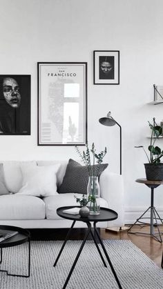 a living room filled with furniture and pictures on the wall above it's coffee table