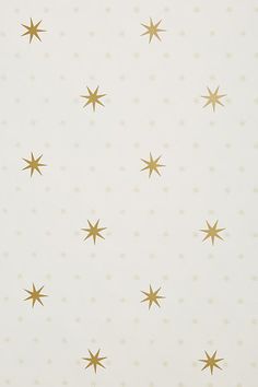 gold stars on white wallpaper in a room with no one at the table or chair