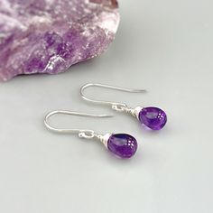 Handmade Amethyst sterling silver boho earrings for women. Purple Amethyst gemstones hang from hand crafted sterling silver, Rose Gold Fill or 14k Gold Fill ear wires or leverbacks. Dainty lightweight earrings perfect for everyday wear.  Handmade Jewelry crafted with love one at a time in my northern Michigan studio. Gemstones are nature's creations and may vary slightly in color and inclusions, but all are lovely and hand selected to match. These earrings are Dainty approx 3/4" (18mm) long including the ear wires / leverbacks. The gemstones are approx. 1/4" wide Amethyst is February's birthstone. We have more Handmade Amethyst jewelry, hair accessories, and hair jewelry available in our store: https://www.etsy.com/shop/BlueHeronJewelry?ref=seller-platform-mcnav&search_query=Amethyst I lov Amethyst Drop Earrings Fine Jewelry, Gemstone Drop Earrings As A Gift For Her, Silver Gemstone Crystal Earrings, Fine Jewelry Amethyst Drop Earrings, Purple Long Drop Jewelry With Ear Wire, Sterling Silver Dangle Earrings With Birthstone, Sterling Silver Dangle Jewelry With Birthstone, Sterling Silver Birthstone Dangle Jewelry, Bohemian Sterling Silver Birthstone Jewelry