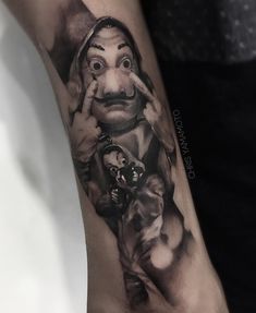 a man's arm with a tattoo on it that has an image of the wizard and his dog