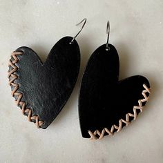 Show your love with these leather heart earrings! Irregular, and uniquely shaped vegetable-tanned leather hearts are accented along the sides with leather cord stitching. Surgical steel ear wires. Large size hangs 2.5" long and measures 1.5" wide; small sizes hangs 2” long and measures 1” wide. Leather Jewelry Making, Handmade Leather Jewelry, Diy Leather Earrings, Idee Cricut, Diy Leather Projects, Leather Jewelry Diy, Leather Lacing, Leather Jewels, Leather Craft Projects