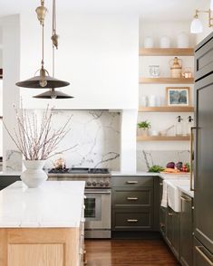 a kitchen with marble counter tops and stainless steel appliances