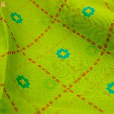 the fabric is bright green and has blue stars on it, as well as orange dots