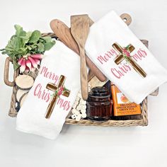 a basket filled with towels and other items on top of a white tablecloth covered tray