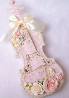 a violin decorated with flowers and pearls