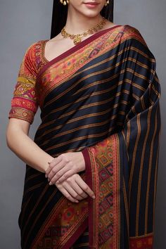 Black saree with madhuhira print, striped detail and geometric motif border. Comes with blouse.
Component: 2
Embroidered, Printed
Neckline: Leaf
Sleeve Length: Half
Fabric: Silk, Satin; Lining: Viscose
Color: Black
Striped pattern
Tassel tie-up back
Closure: Blouse: Back hooks - Aza Fashions Festive Black Blouse With Printed Border, Festive Black Blouse Piece With Printed Border, Navratri Blouse With Printed Motifs, Black Block Print Blouse Piece For Navratri, Traditional Blouse With Printed Border For Navratri, Bollywood Blouse With Printed Border For Navratri, Traditional Blouse With Printed Border, Traditional Semi-stitched Blouse With Printed Border, Multicolor Blouse With Printed Border For Navratri