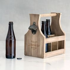 a wooden bottle opener with two bottles in it