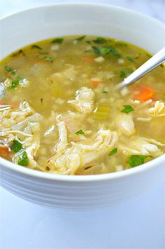 a white bowl filled with chicken and vegetable soup