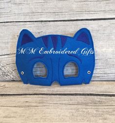 a blue cat mask with the words mr and mrs embroidered on it's face