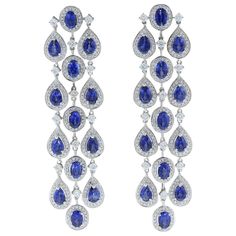 Three chandelier drops of 15.27 carats oval and pear cut blue sapphires adorn this pair of dancing earrings. Each of the deep ocean blue sapphires are haloed and linked by 4.36 carts of VS quality colorless diamonds. The delicate rainfall style of this pair of earrings set in 18K white gold is one to last an eternity. Earring Length: 3.00 inches Earring Width: 1.00 inch Sapphire Earrings Drop, The Deep Ocean, Blue Jewellery, Dance Earrings, Blue Sapphire Jewelry, Pearl Chandelier Earrings, Gold Chandelier Earrings, Antique Jewelry Indian, Deep Ocean