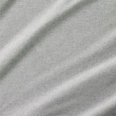 a close up view of a plain grey fabric textured with thin lines and folds