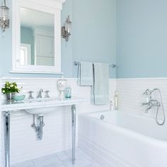 a bathroom with blue walls and white tiles on the floor is pictured in this image