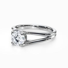 a white gold engagement ring with a round diamond in the center