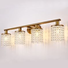 three lights with crystal shades on the wall