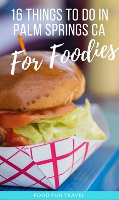 a hamburger with lettuce and tomato in it on top of a blue table