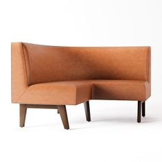 a brown leather couch sitting on top of a wooden frame