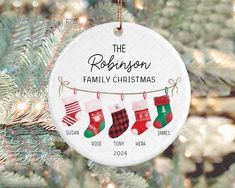 personalized family christmas ornament hanging from a tree with stockings and socks on it