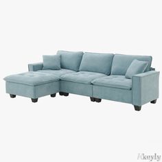 a blue sectional couch with pillows on it's back and arms, sitting against a white background