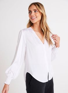 This stylish satin finish blouse is the perfect addition to your wardrobe. With its smocked cuff and button-down design, it offers a comfortable and trendy fit. Whether you're dressing up for a special occasion or keeping it casual, the Smocked Cuff Button Down is sure to make a statement. 100% Satin Ecovero. Elegant Blouse With Balloon Sleeves And Smocked Cuffs, Elegant Tops With Balloon Sleeves And Smocked Cuffs, Elegant Balloon Sleeve Tops With Smocked Cuffs, Elegant Balloon Sleeve Top With Smocked Cuffs, Classic Blouse With Balloon Sleeves And Button Cuffs, Chic Blouse With Smocked Cuffs For Brunch, Button-up Blouse With Smocked Cuffs For Work, Feminine Workwear Blouse With Smocked Cuffs, Button-up Workwear Blouse With Smocked Cuffs