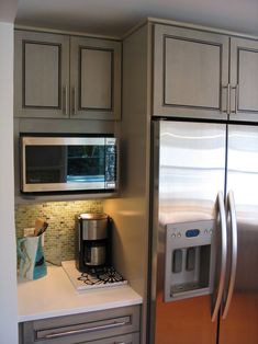 a kitchen with stainless steel appliances and cabinets